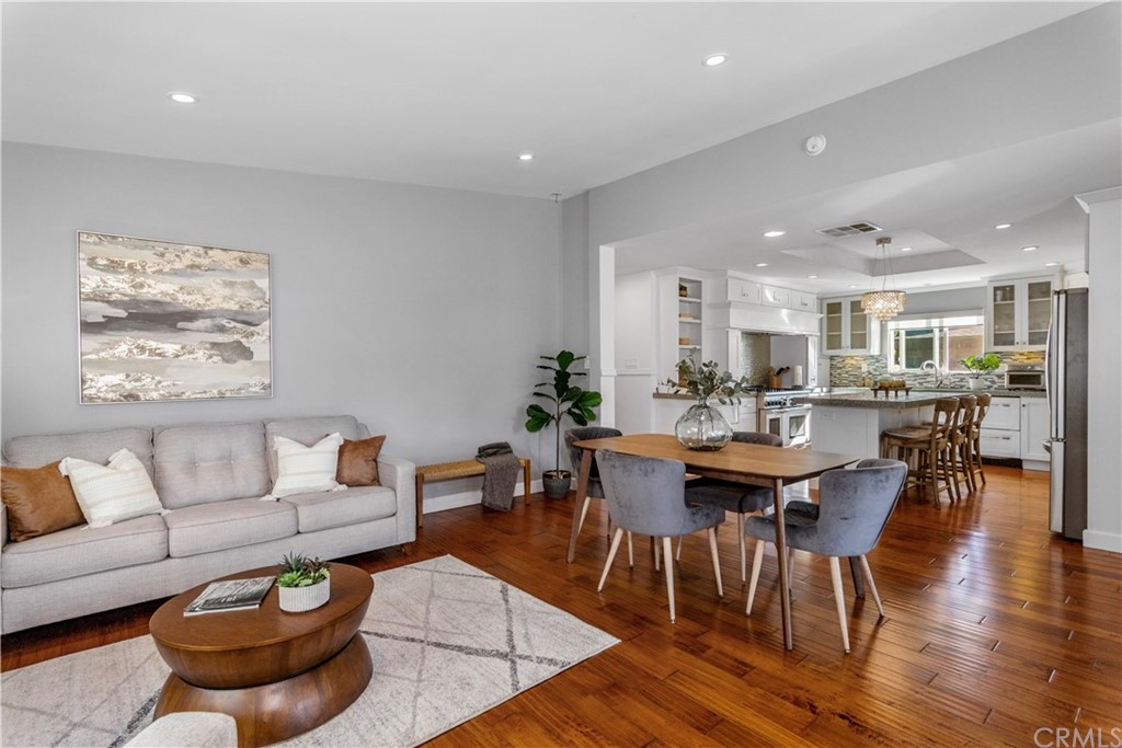377 Flint Avenue Long Beach, CA 90814 - Photo 14 of 41 a living room with furniture a wooden floor and a kitchen