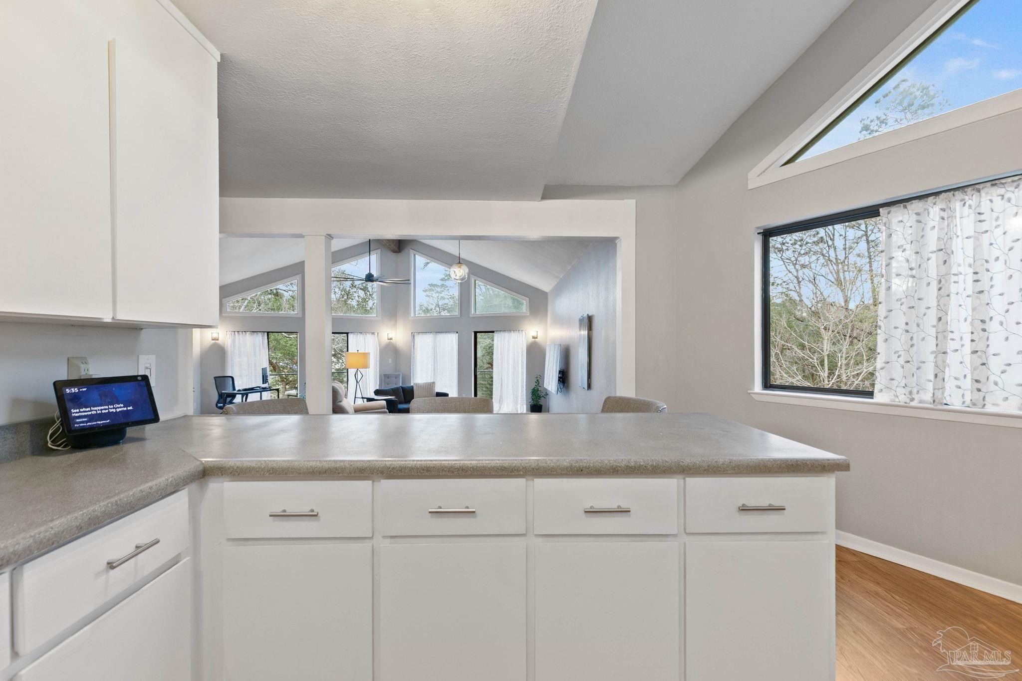 11424 High Springs Road Pensacola, FL 32534 - Photo 12 of 46 a view with granite countertop a sink white cabinets and a wooden floor