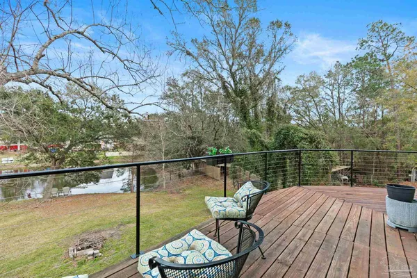 a view of balcony with wooden floor and outdoor seating