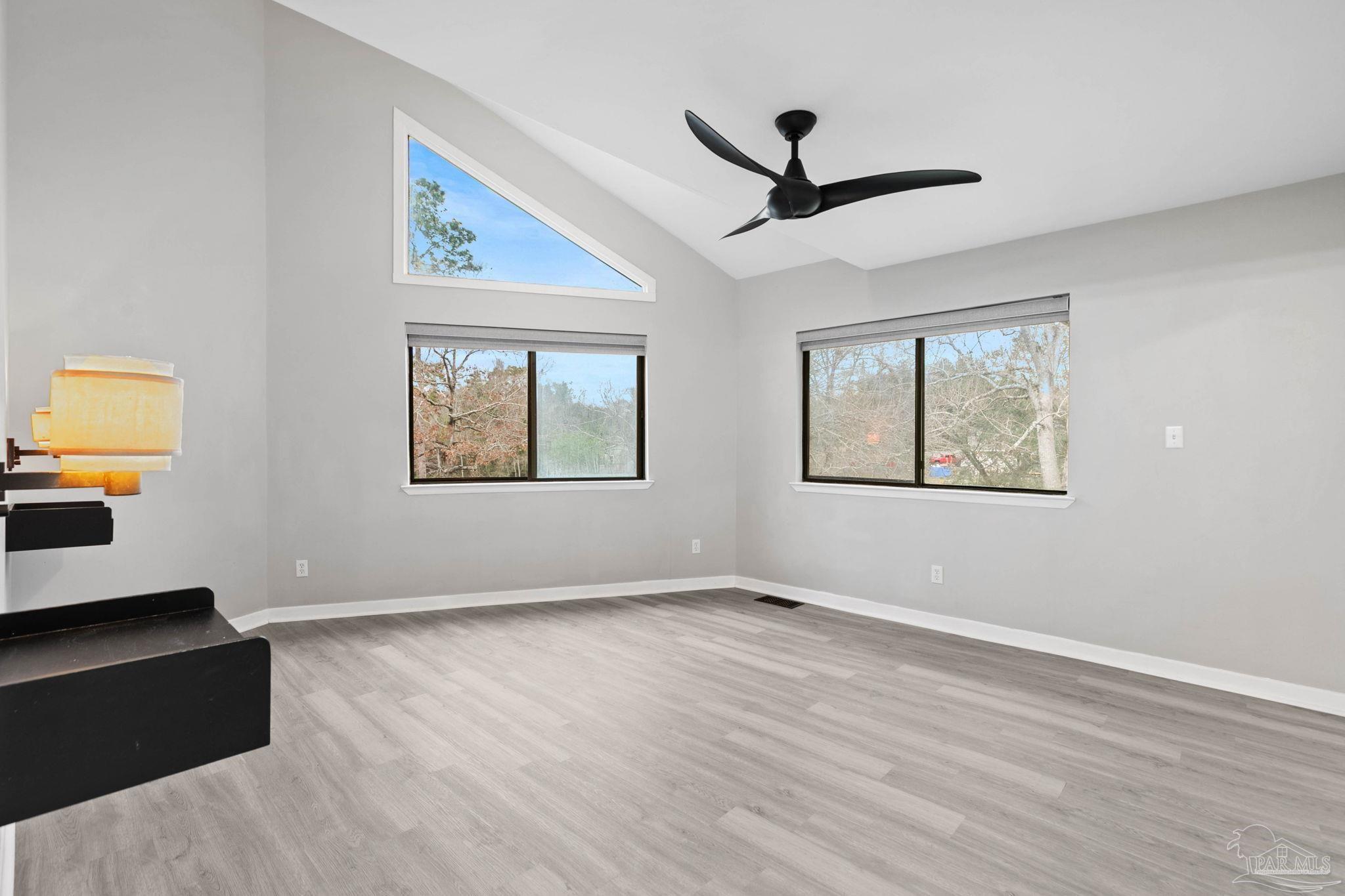 11424 High Springs Road Pensacola, FL 32534 - Photo 16 of 46 a view of an empty room with wooden floor and a window
