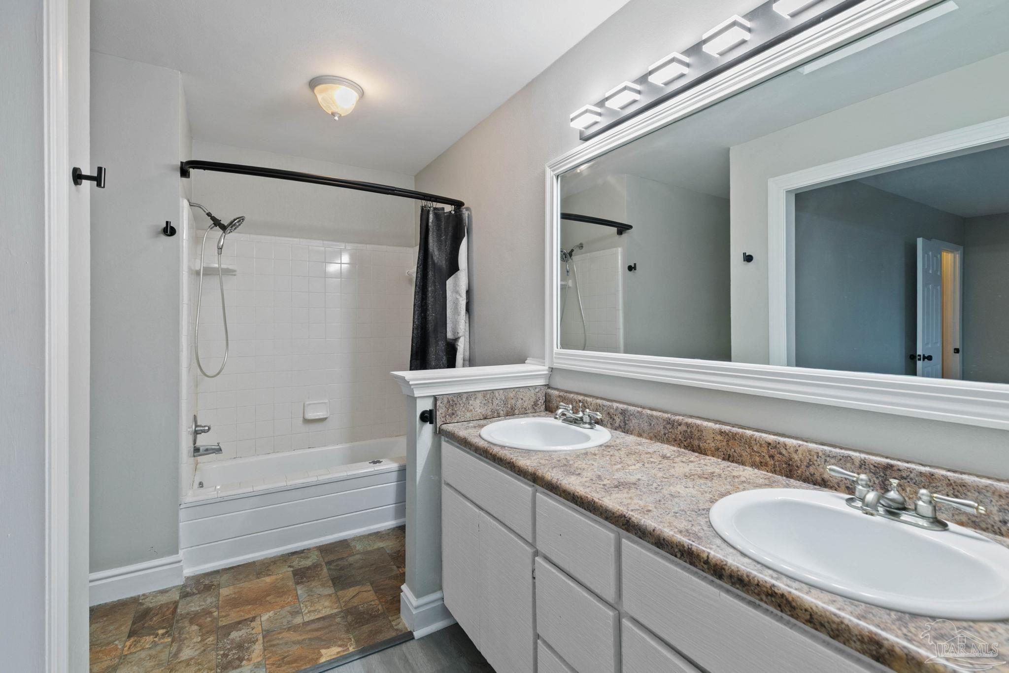 11424 High Springs Road Pensacola, FL 32534 - Photo 17 of 46 a bathroom with a granite countertop sink mirror and shower