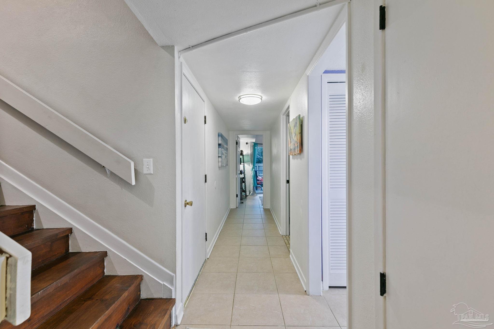 11424 High Springs Road Pensacola, FL 32534 - Photo 19 of 46 a view of a hallway with wooden floor and staircase