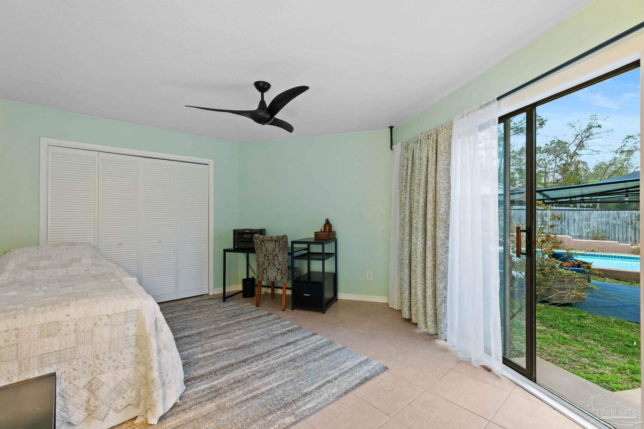 11424 High Springs Road Pensacola, FL 32534 - Photo 20 of 46 a bedroom with a bed and a large window