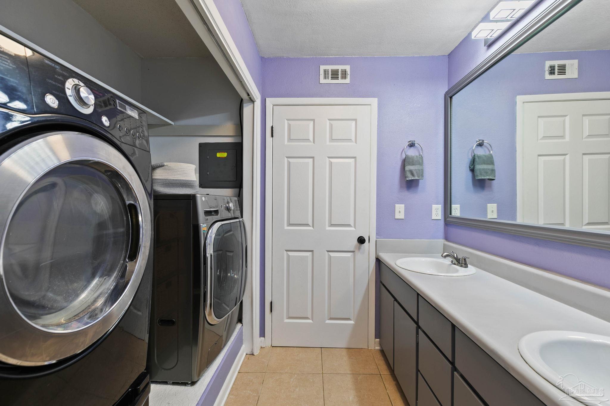 11424 High Springs Road Pensacola, FL 32534 - Photo 21 of 46 a bathroom with a sink a washer and dryer