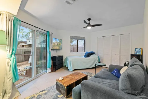 a bedroom with a bed and a mirror on dresser