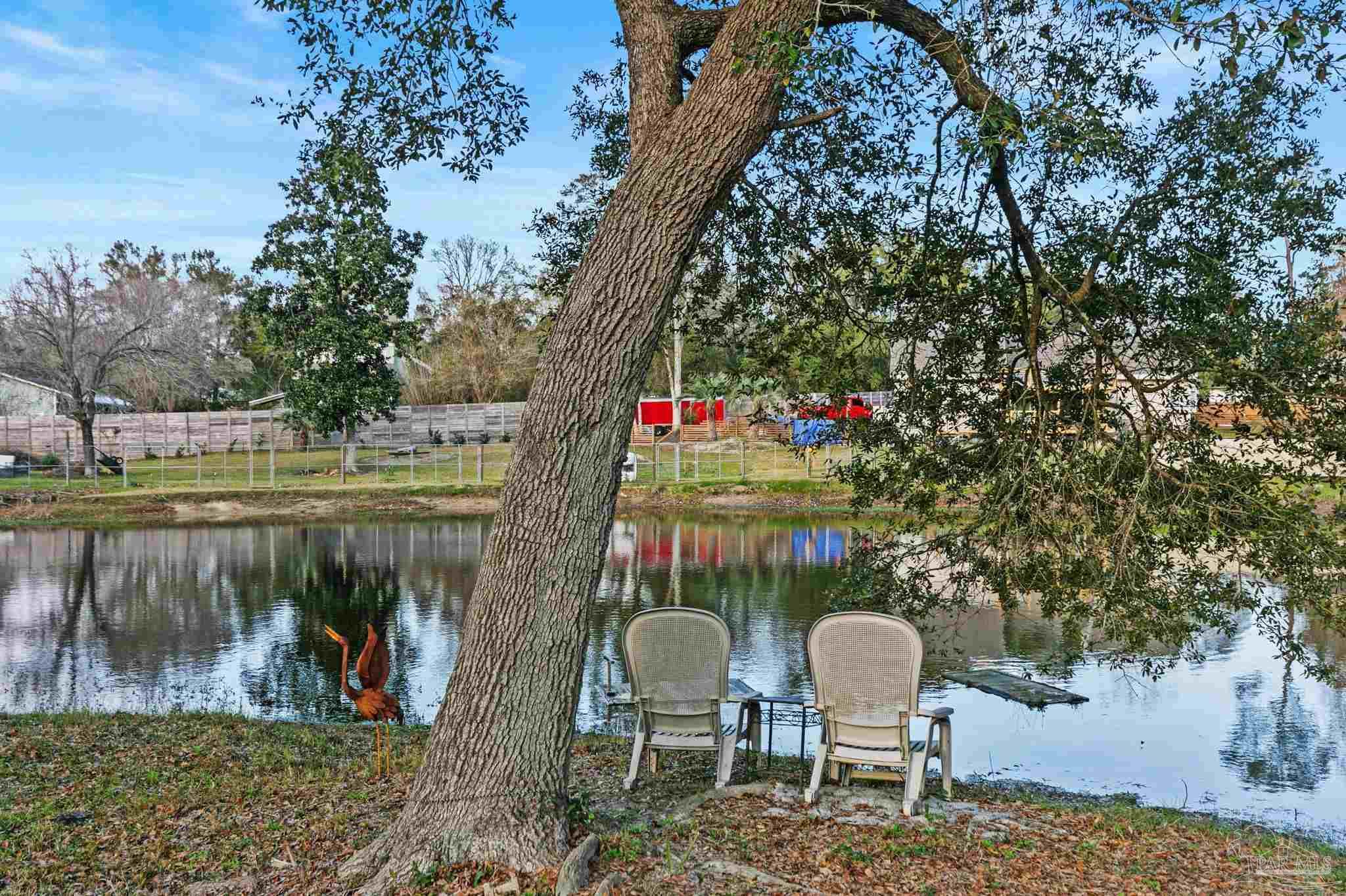 11424 High Springs Road Pensacola, FL 32534 - Photo 37 of 46 a two chairs sitting in a backyard of a house