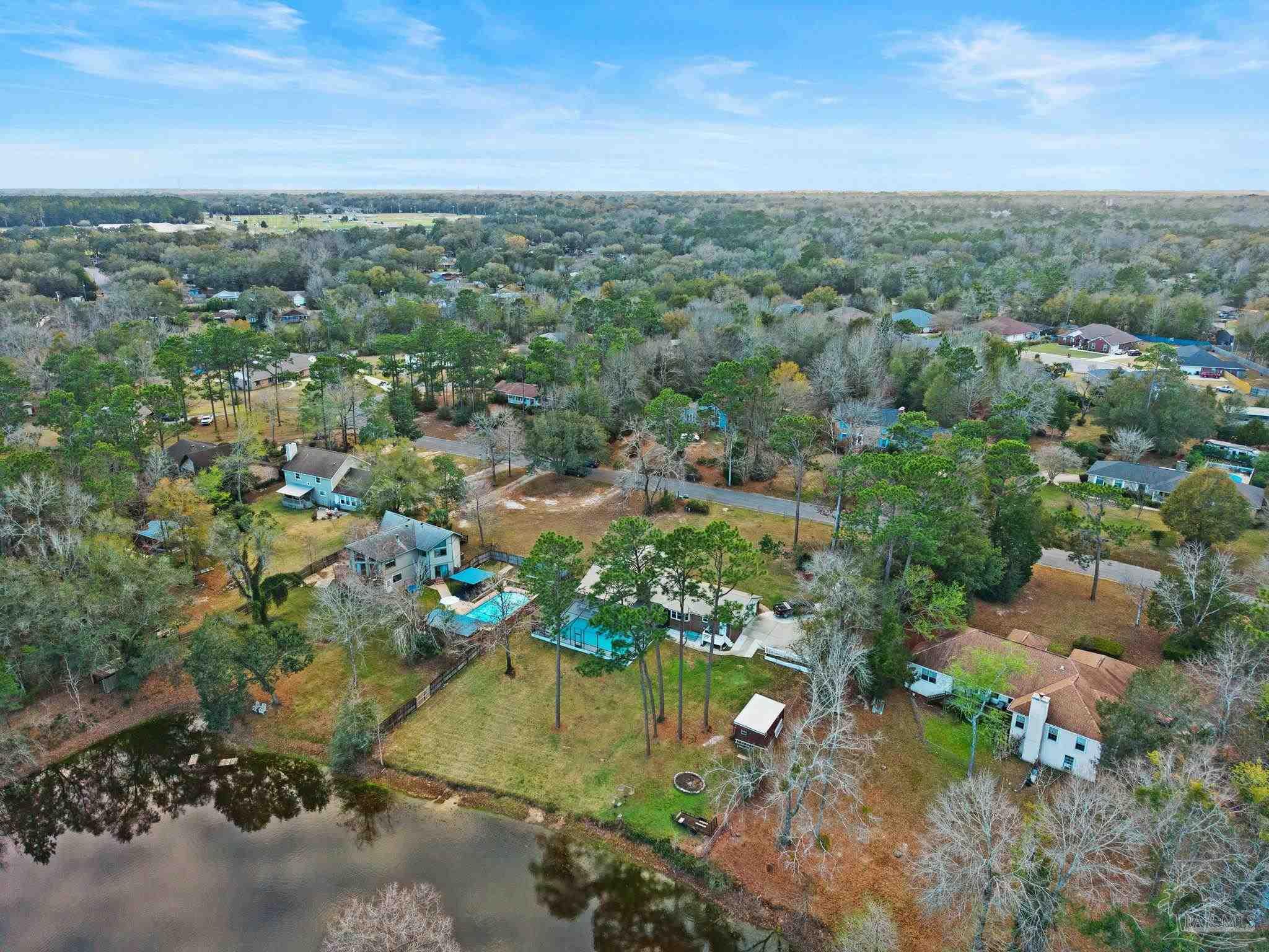 11424 High Springs Road Pensacola, FL 32534 - Photo 41 of 46 an aerial view of residential houses with outdoor space and trees