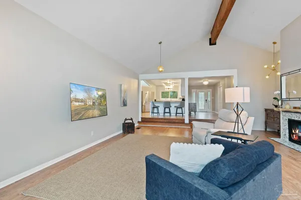 a living room with furniture a fireplace and a window