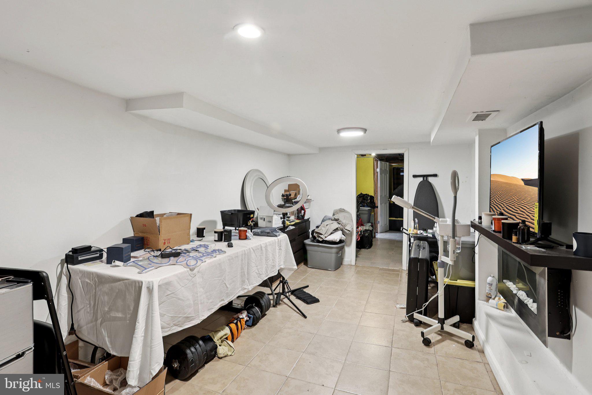 115 North Peach Street Philadelphia, PA 19139 - Photo 11 of 19 a room with gym equipment and a flat screen tv