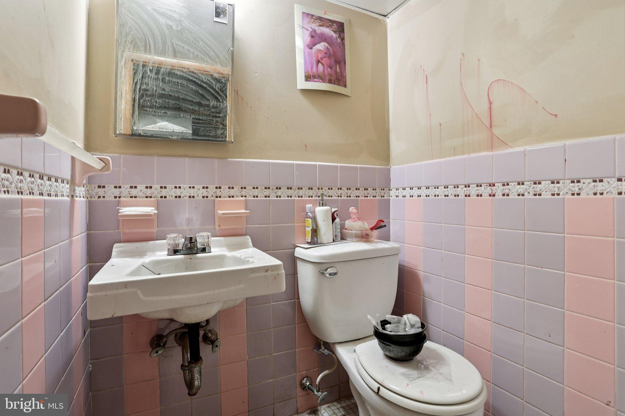 115 North Peach Street Philadelphia, PA 19139 - Photo 13 of 19 a bathroom with a sink a toilet and a mirror