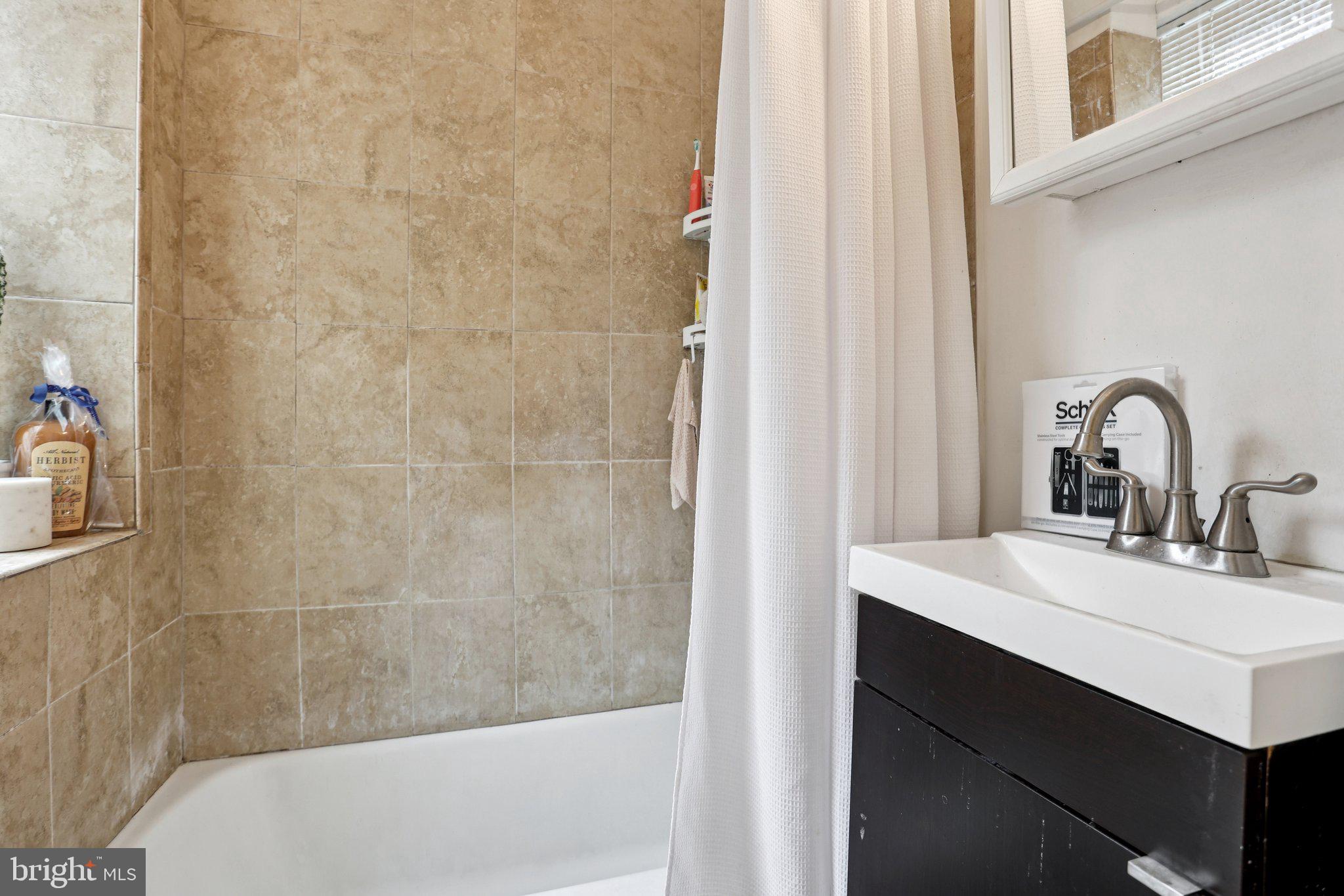 115 North Peach Street Philadelphia, PA 19139 - Photo 9 of 19 a bathroom with a sink and a mirror