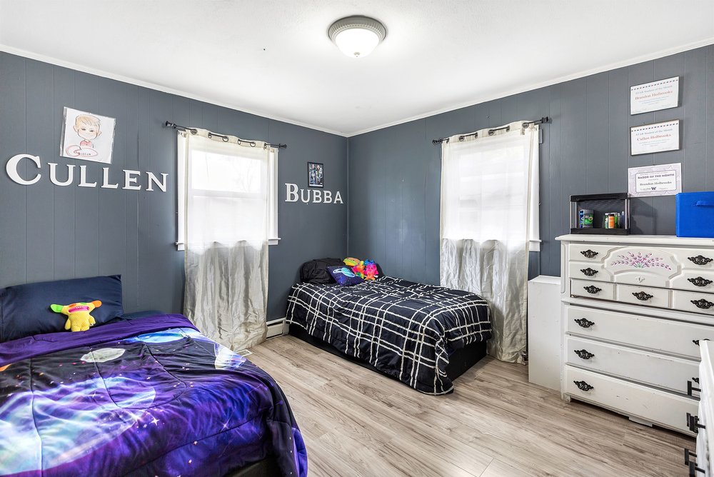 920 White Cut Road Walhalla, SC 29691 - Photo 11 of 23 This spacious bedroom features ample natural light and durable wood-like flooring, creating a comfortable and inviting atmosphere.