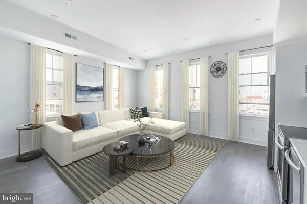 a living room with furniture and a large window