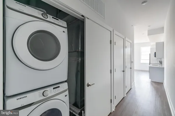 a view of a hallway with washer and dryer