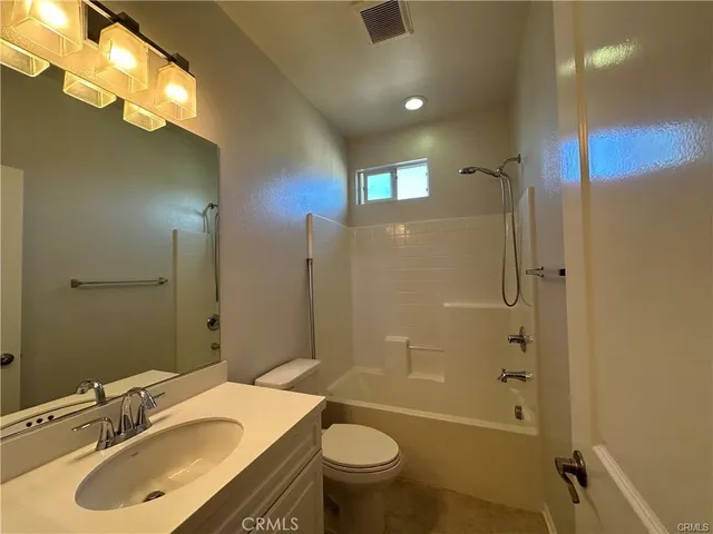 a bathroom with a shower sink and mirror