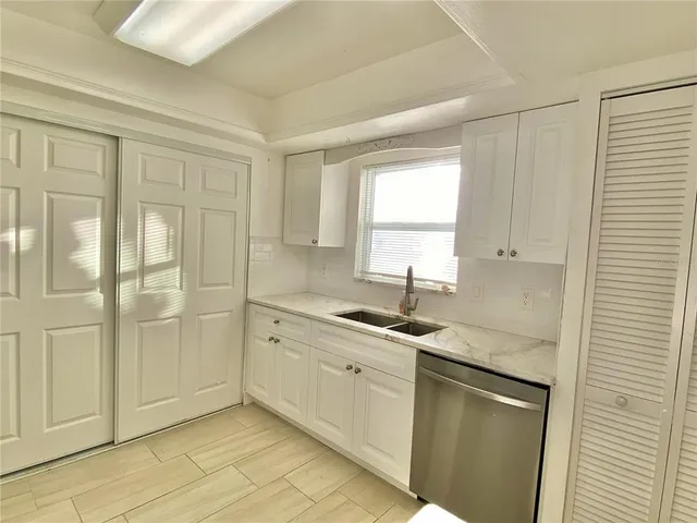 a kitchen with a sink and cabinets