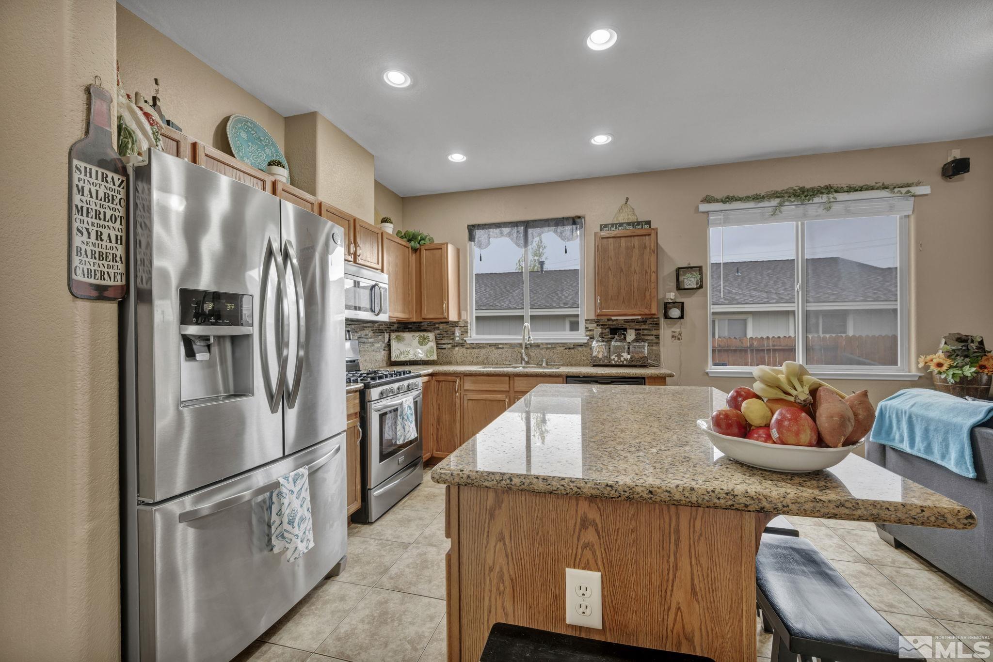 2721 Harding Way Reno, NV 89503 - Photo 15 of 40 a kitchen with stainless steel appliances granite countertop a refrigerator and a sink