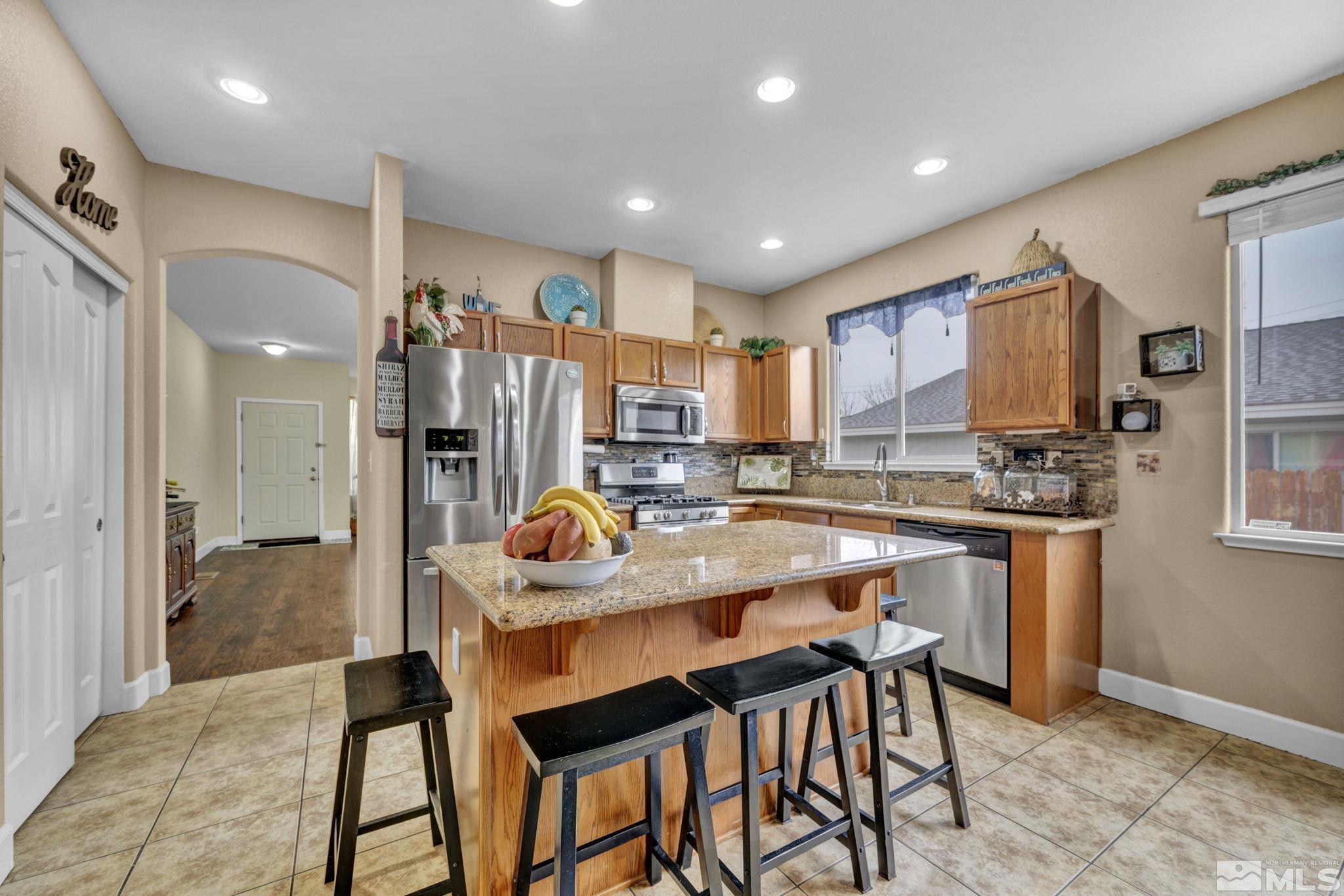 2721 Harding Way Reno, NV 89503 - Photo 16 of 40 a kitchen with a table chairs sink and refrigerator