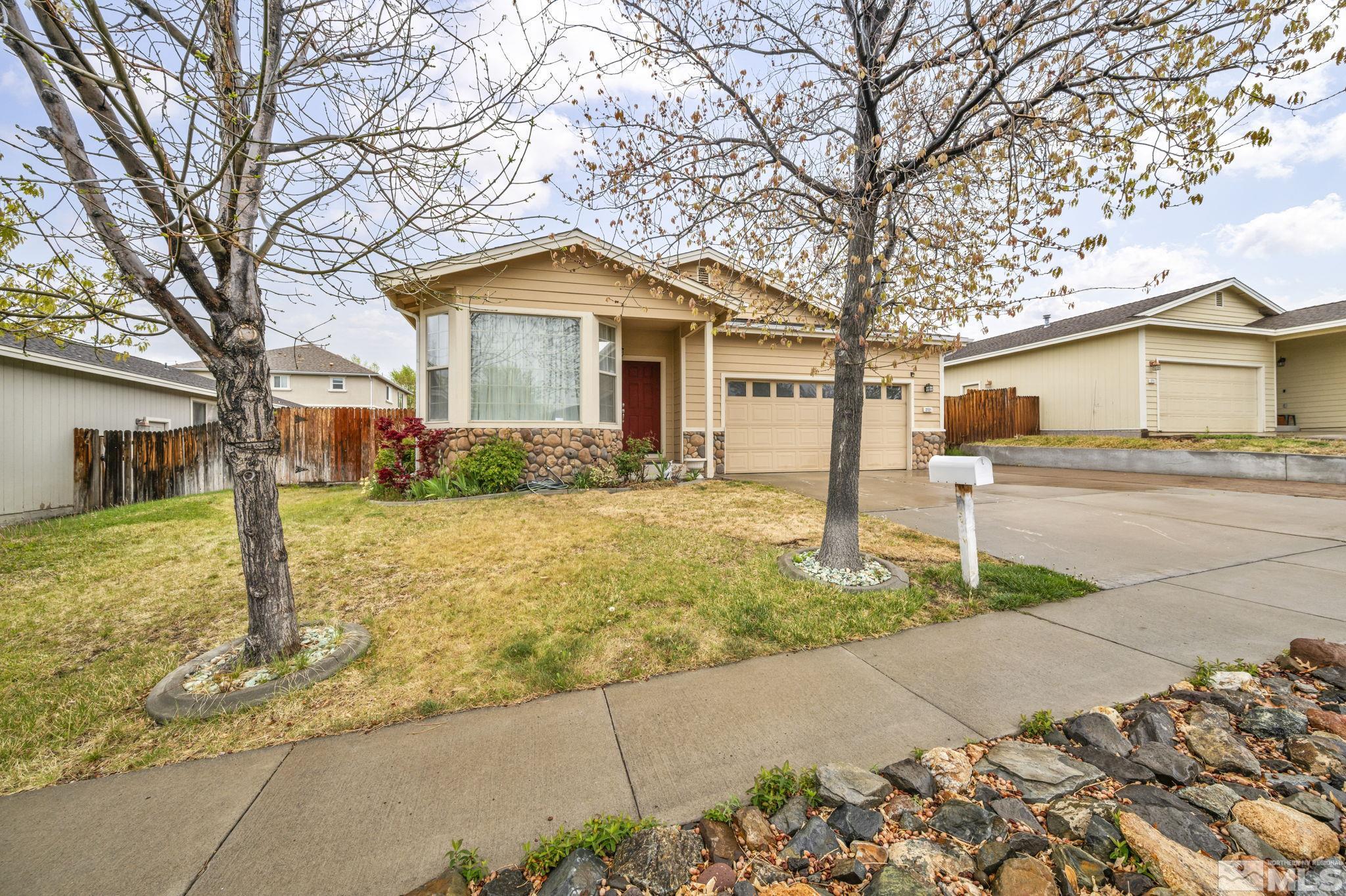 2721 Harding Way Reno, NV 89503 - Photo 2 of 40 a front view of a house with a yard and garage