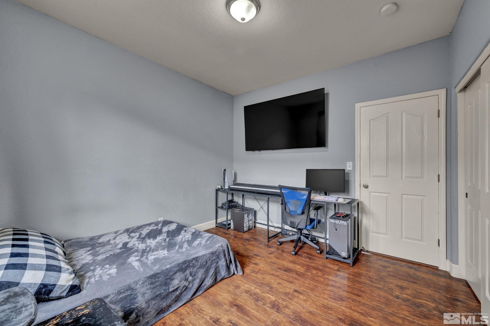 2721 Harding Way Reno, NV 89503 - Photo 23 of 40 a bedroom with a bed and a flat screen tv