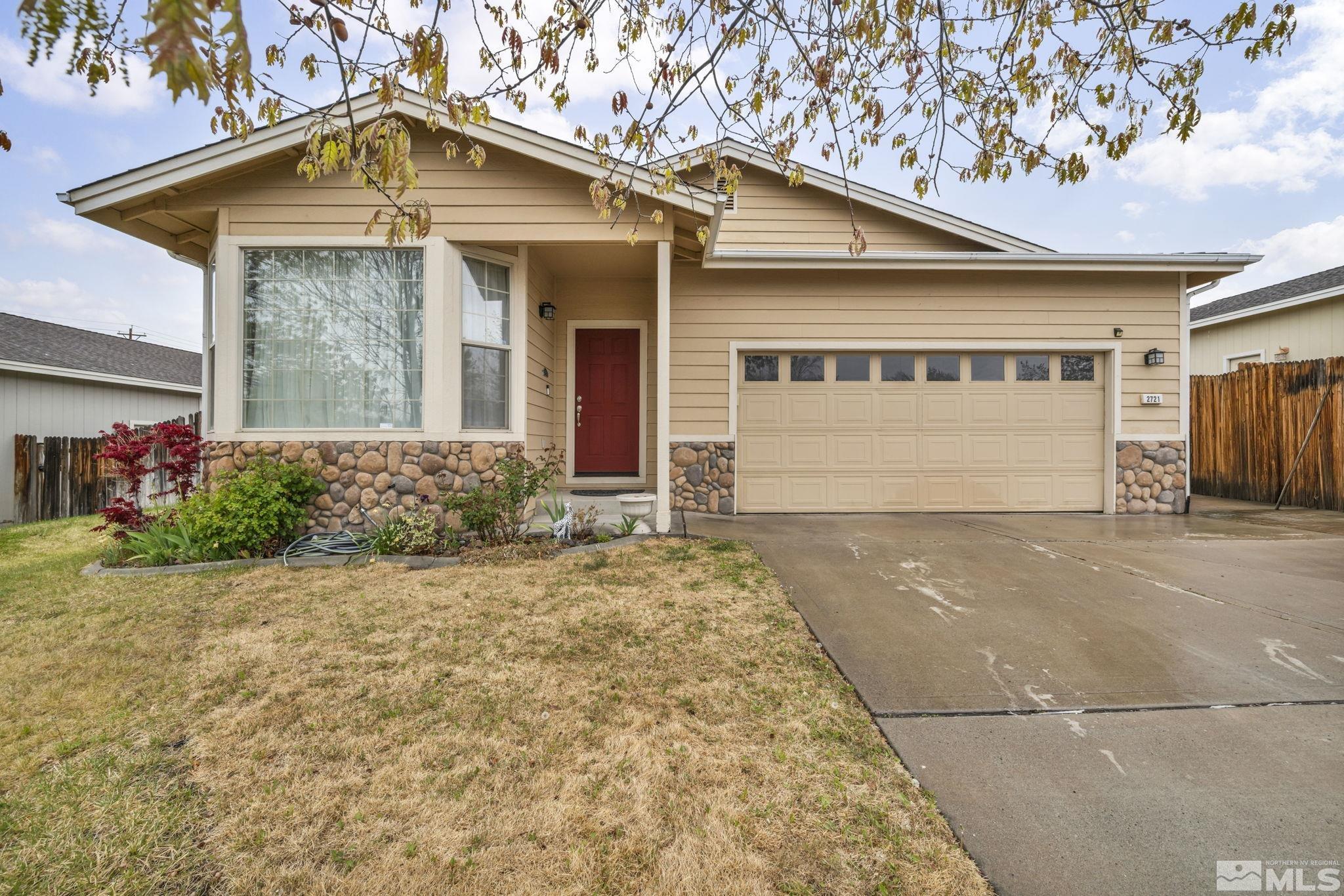 2721 Harding Way Reno, NV 89503 - Photo 3 of 40 a front view of a house with a yard and garage