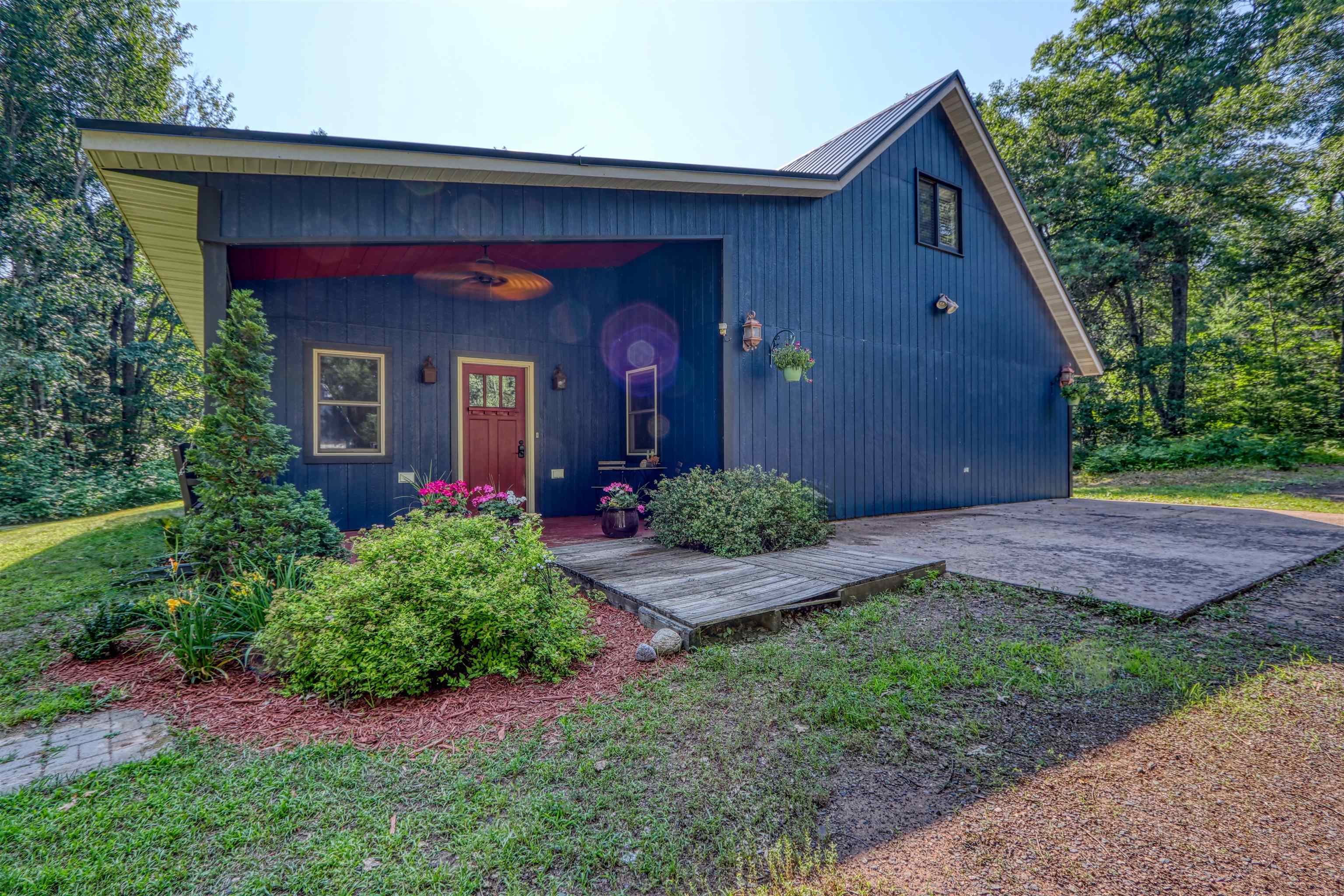 15531 West Hospital Road Hayward, WI 54843 - Photo 2 of 71 View of front of house with a metal roof and covered porch