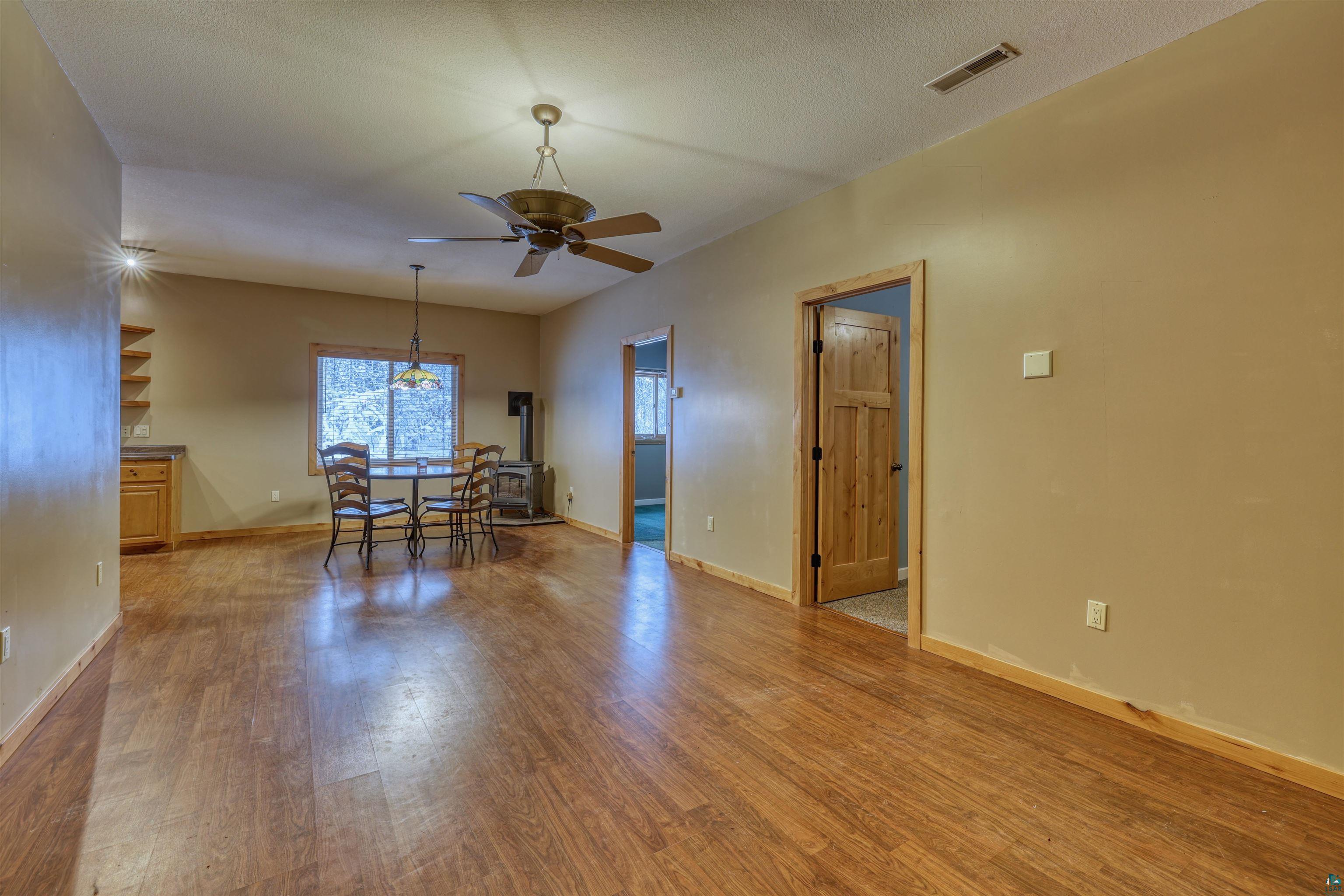 15531 West Hospital Road Hayward, WI 54843 - Photo 23 of 71 Empty room featuring light wood-type flooring, a textured ceiling, and a ceiling fan