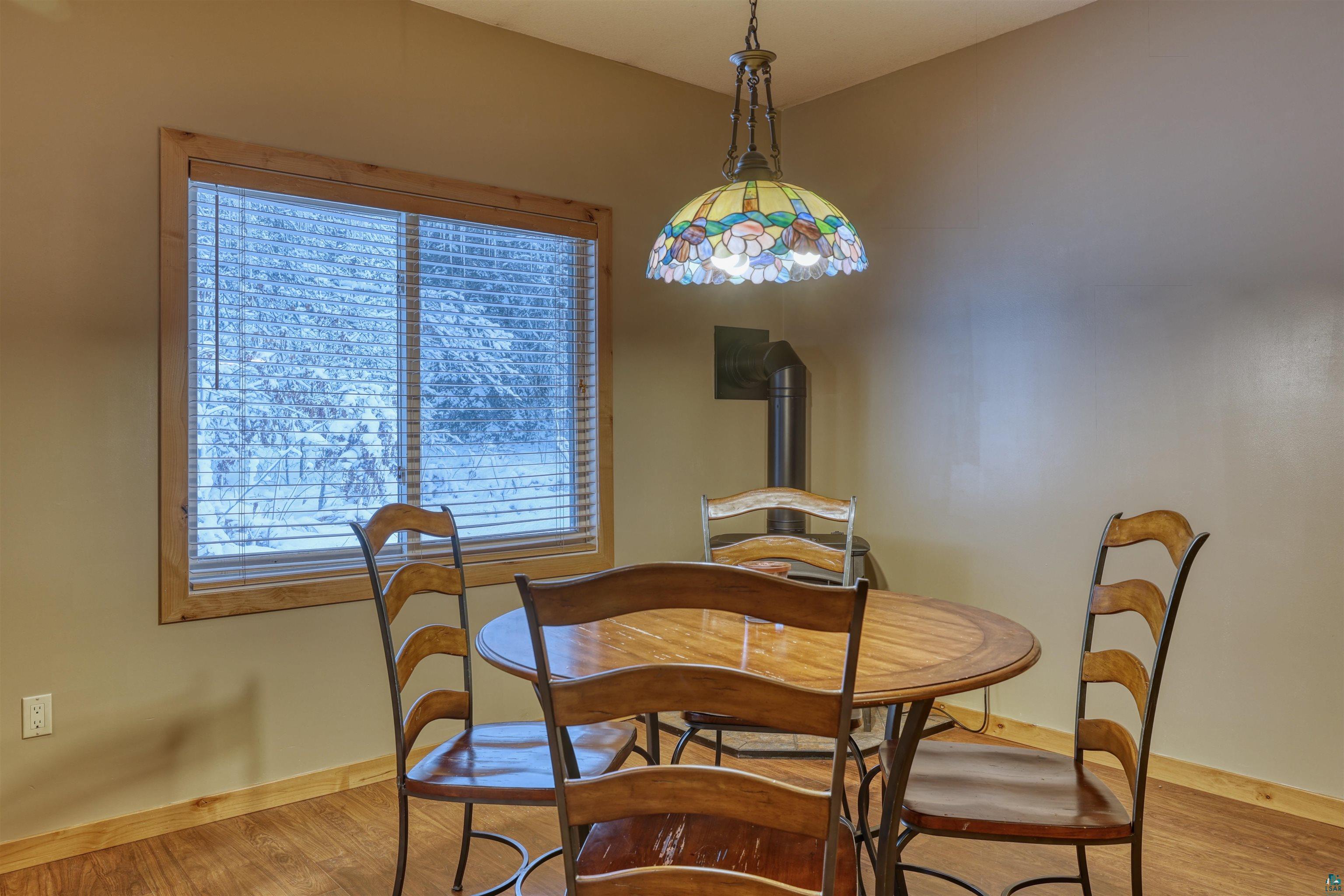 15531 West Hospital Road Hayward, WI 54843 - Photo 27 of 71 Dining area featuring a wood stove and wood finished floors