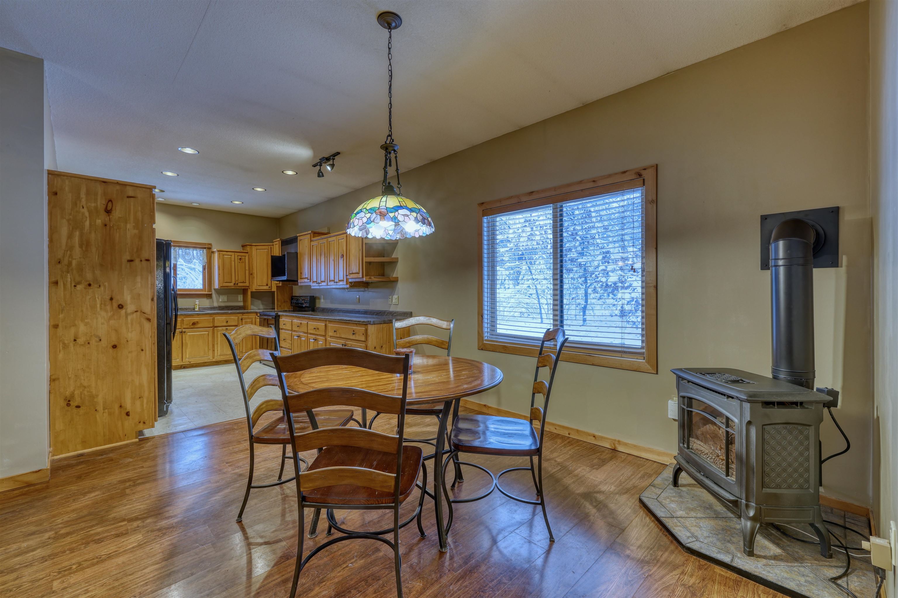 15531 West Hospital Road Hayward, WI 54843 - Photo 28 of 71 Dining room featuring a wood stove, recessed lighting, and light wood finished floors