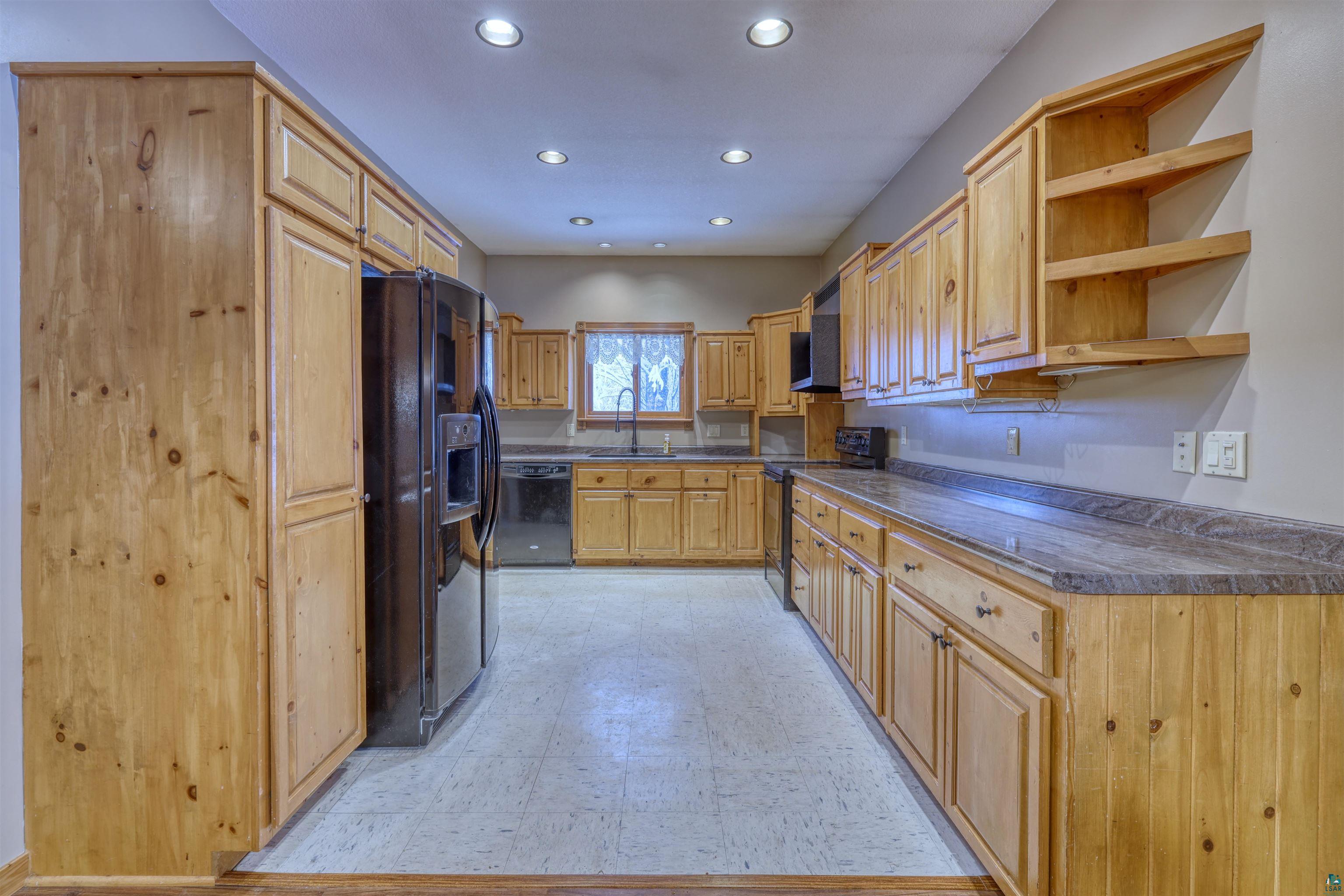 15531 West Hospital Road Hayward, WI 54843 - Photo 29 of 71 Kitchen with light floors, open shelves, black appliances, recessed lighting, and dark countertops
