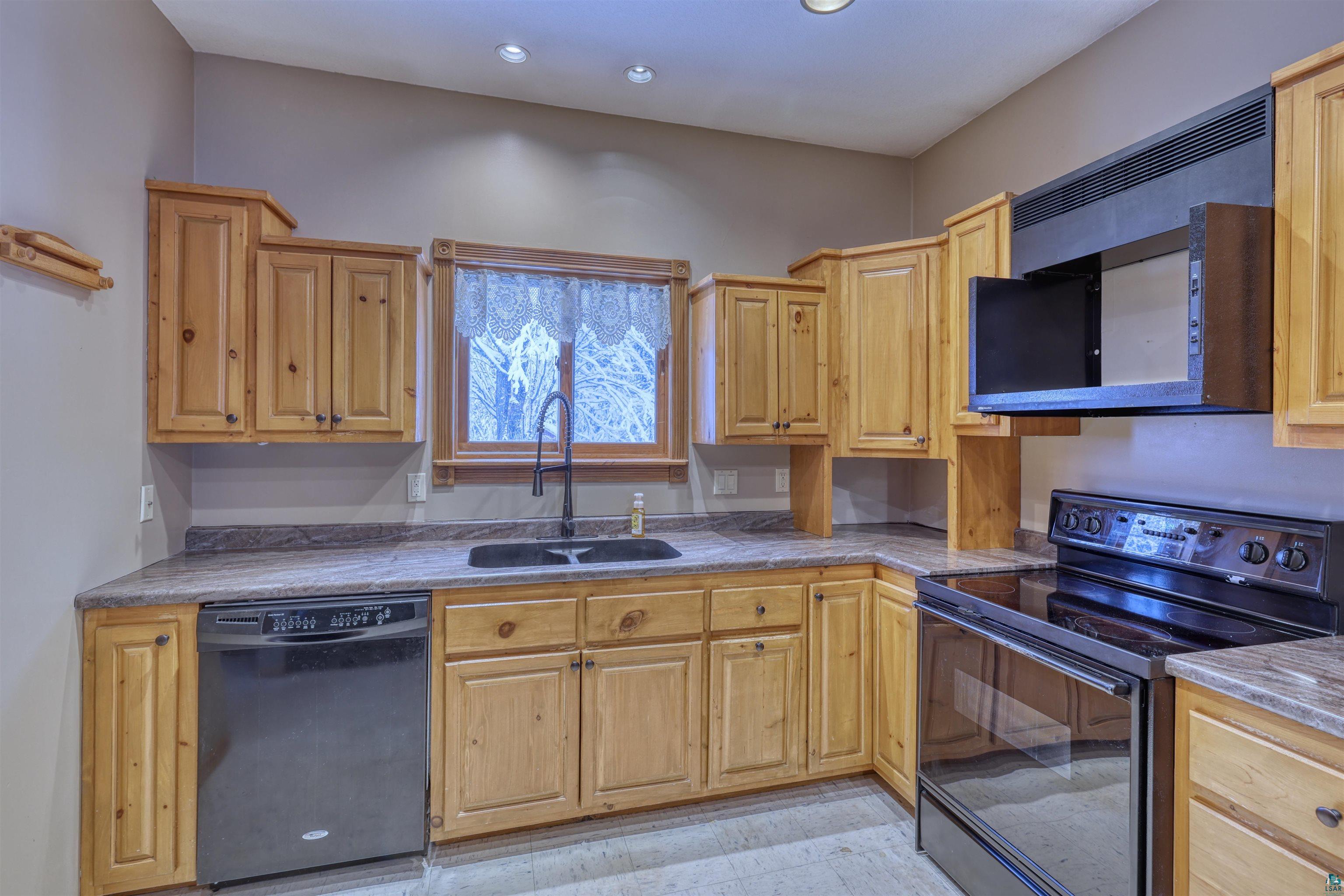 15531 West Hospital Road Hayward, WI 54843 - Photo 31 of 71 Kitchen with black appliances, light stone countertops, and recessed lighting