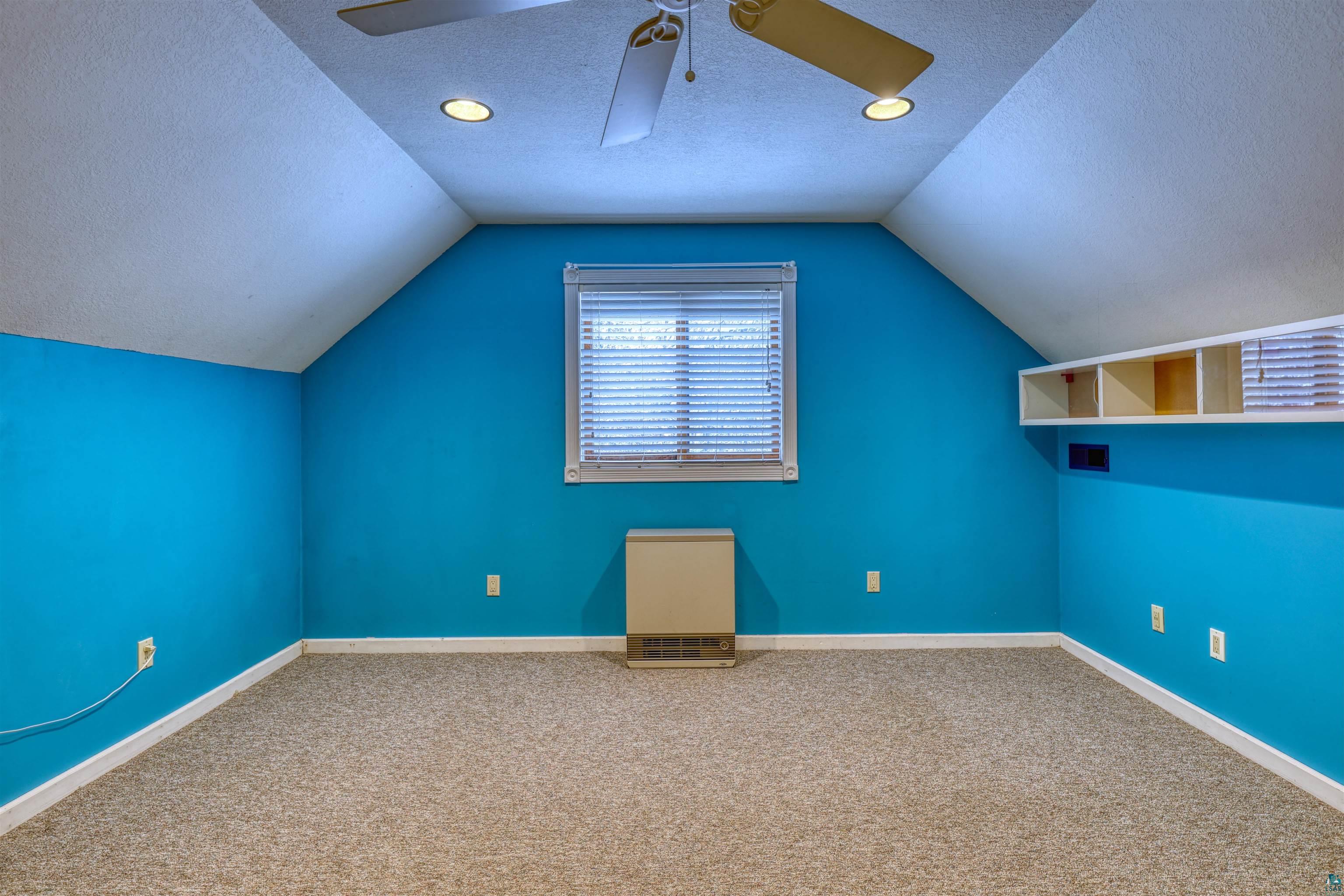 15531 West Hospital Road Hayward, WI 54843 - Photo 48 of 71 Additional living space featuring carpet, vaulted ceiling, a textured ceiling, and ceiling fan