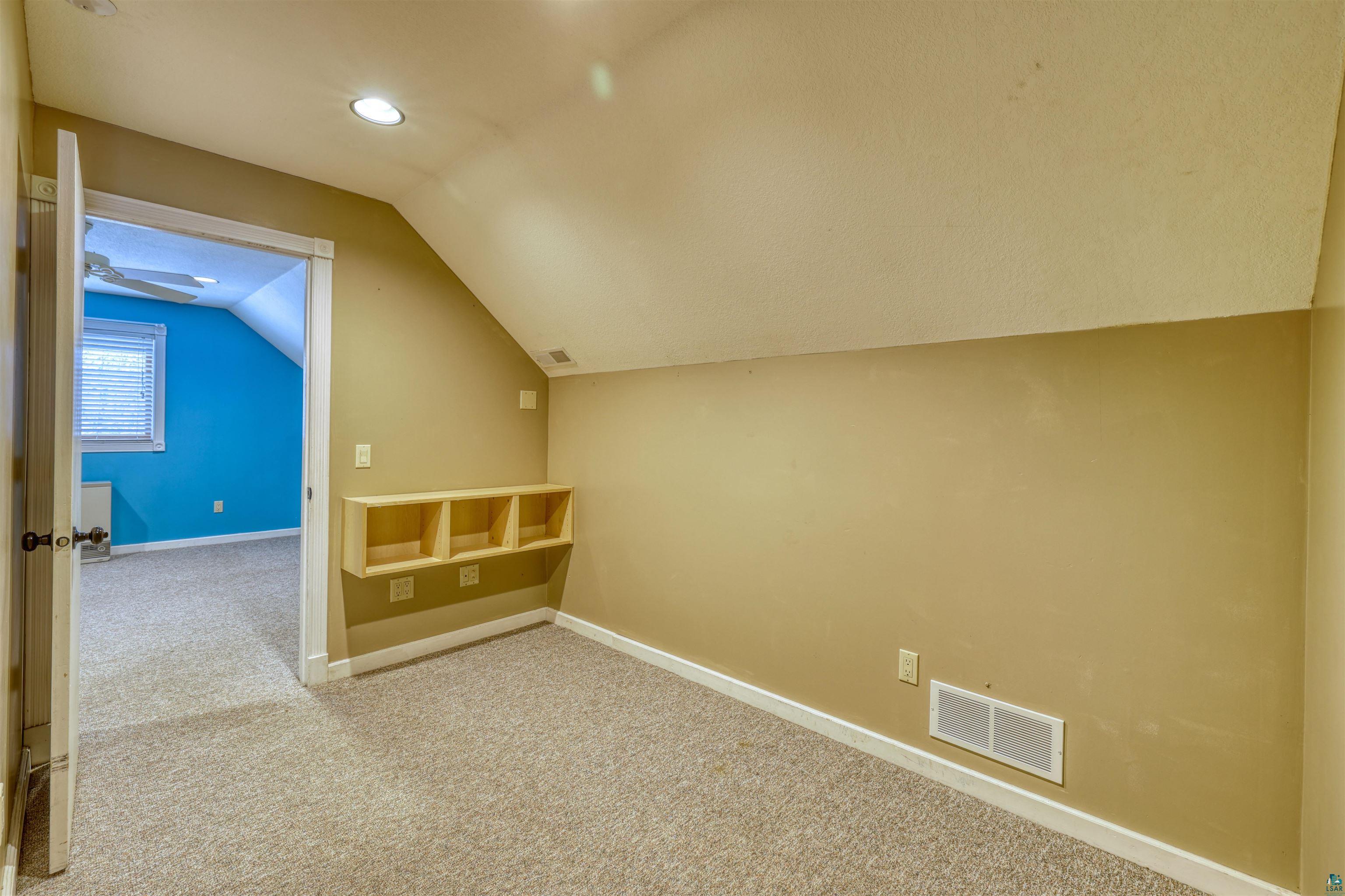 15531 West Hospital Road Hayward, WI 54843 - Photo 49 of 71 Additional living space with light carpet, vaulted ceiling, and recessed lighting