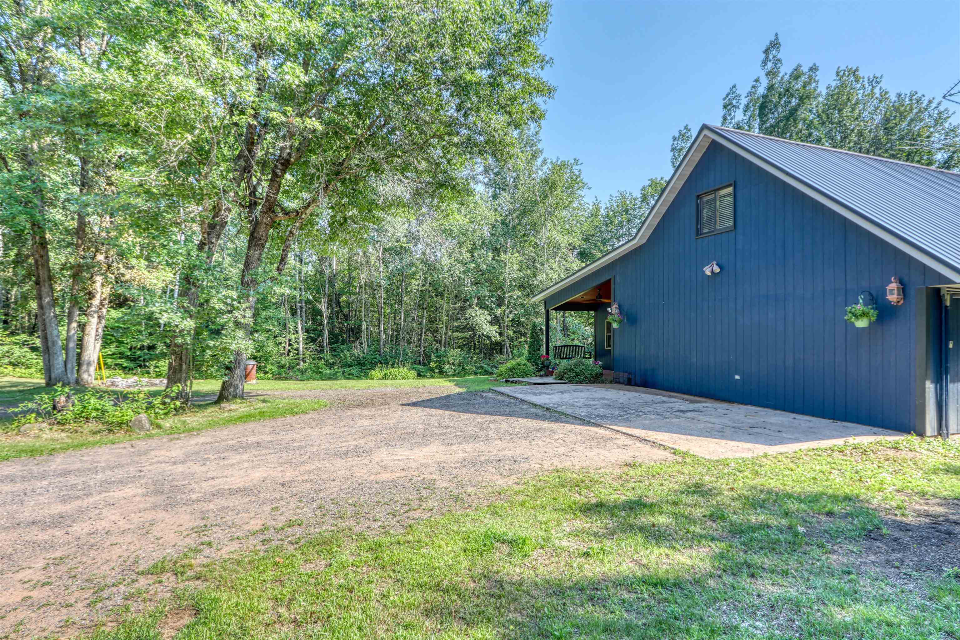 15531 West Hospital Road Hayward, WI 54843 - Photo 54 of 71 View of property exterior with a metal roof and a yard