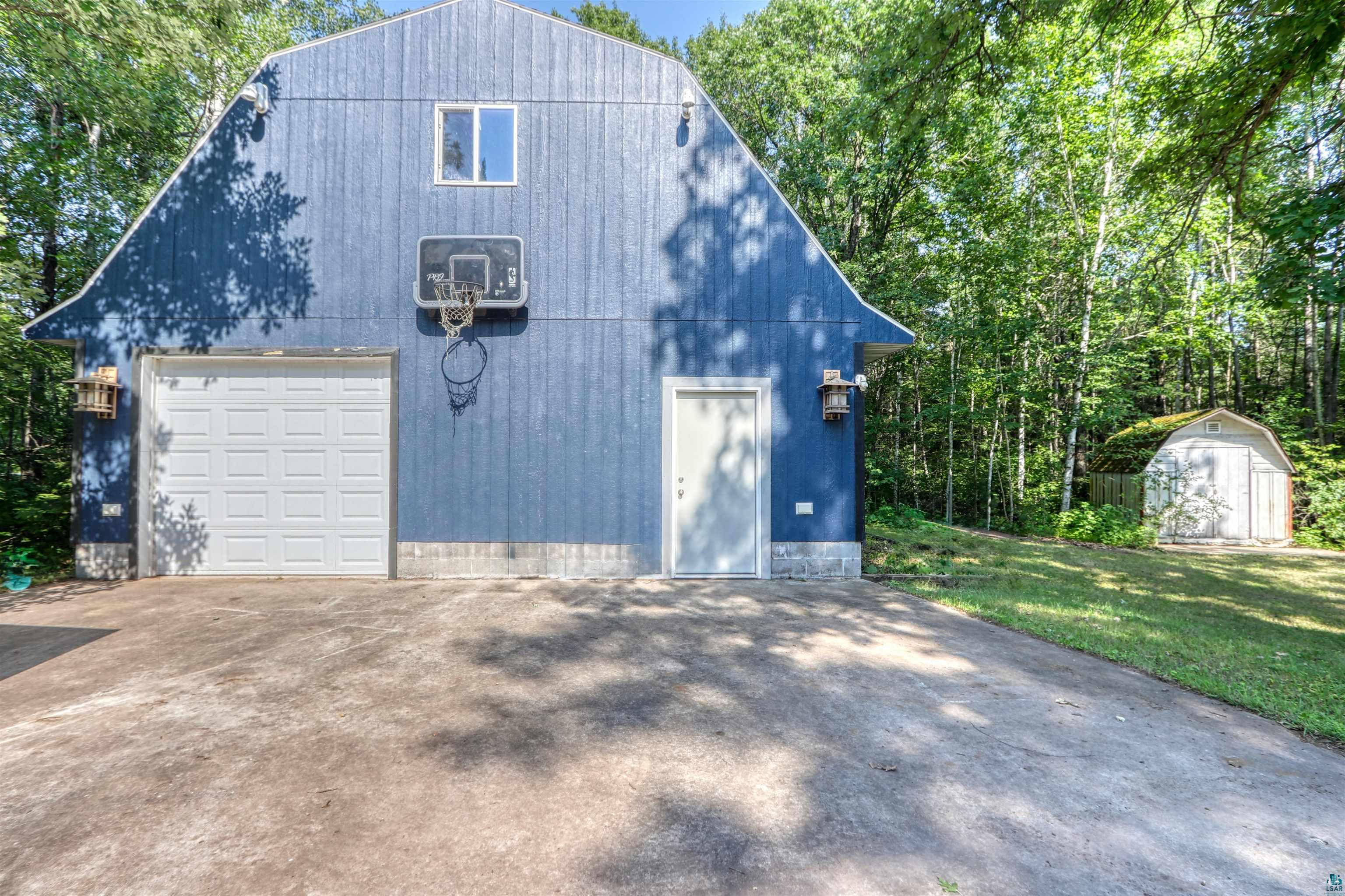 15531 West Hospital Road Hayward, WI 54843 - Photo 9 of 71 Garage featuring driveway, a storage unit, and a garage