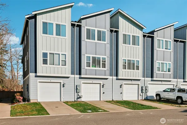 a front view of a residential apartment building with a yard