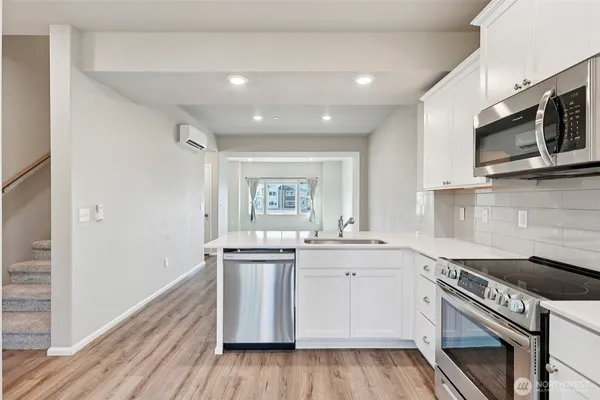 a bathroom with a sink mirror and toilet