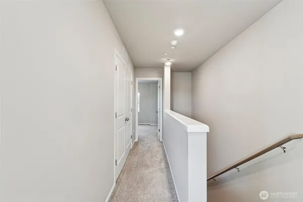 a bedroom with a large bed and a potted plant