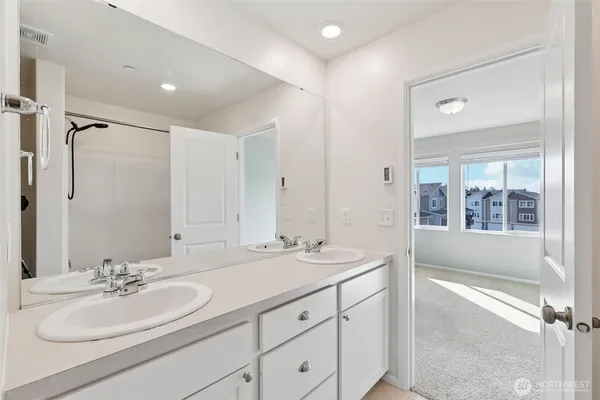 a bathroom with a double vanity sink mirror and double