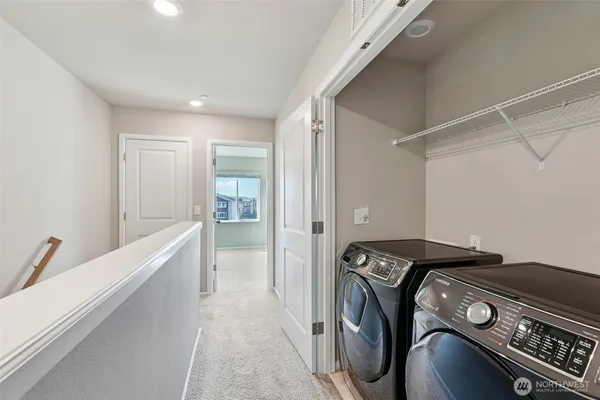 a bedroom with a large bed and a potted plant