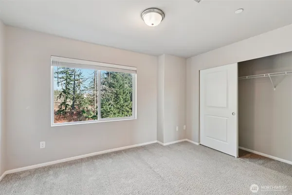 a bedroom with a bed and a potted plant