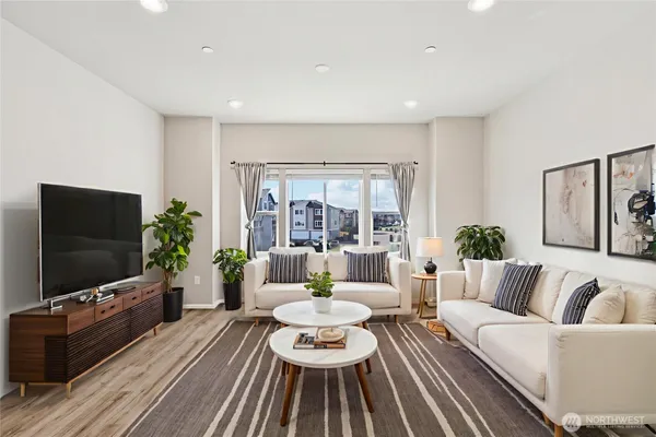 a dining room with furniture and wooden floor