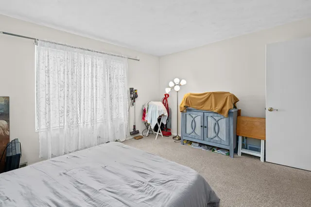 a bedroom with bed and a window