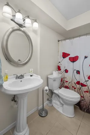 a bathroom with a sink toilet and a mirror