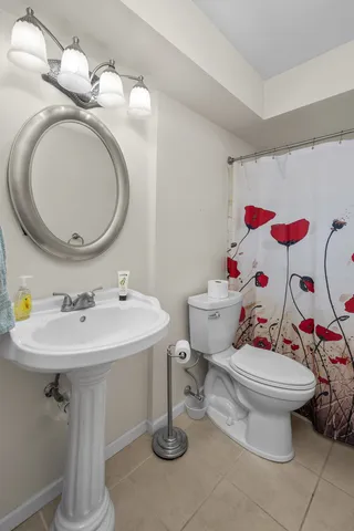 a bathroom with a sink toilet and a mirror