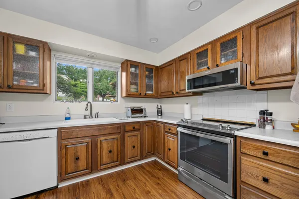 a kitchen with stainless steel appliances granite countertop a sink stove and cabinets