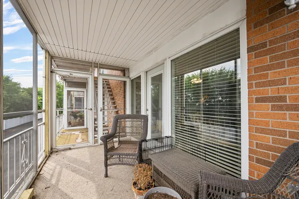 a view of a patio with table and chairs and wooden floor