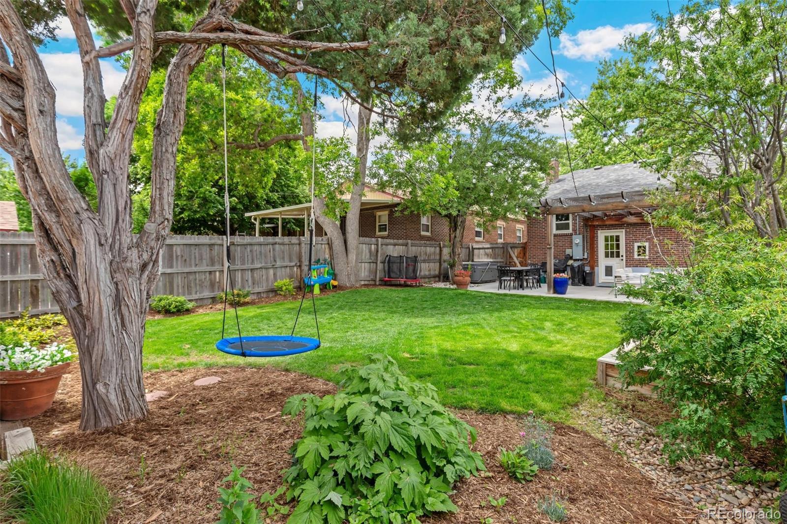 3612 Perry Street Denver, CO 80212 - Photo 31 of 50 a view of a house with a backyard and a tree