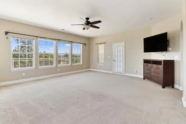 a spacious bathroom with a tub sink and mirror