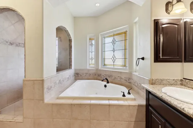 a bathroom with a bathtub and shower